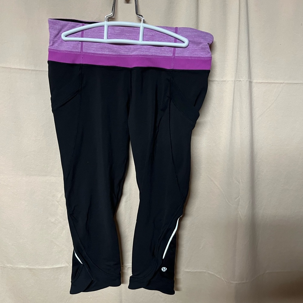 Lululemon cropped 19” legging, black with purple waistband, size 8.